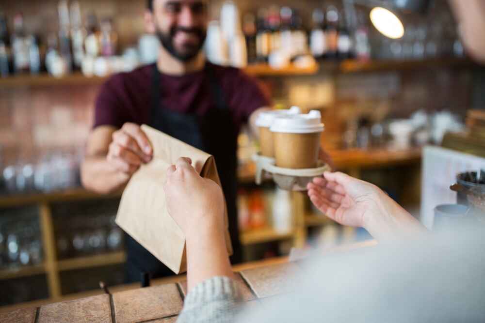 Barista giving someone their order