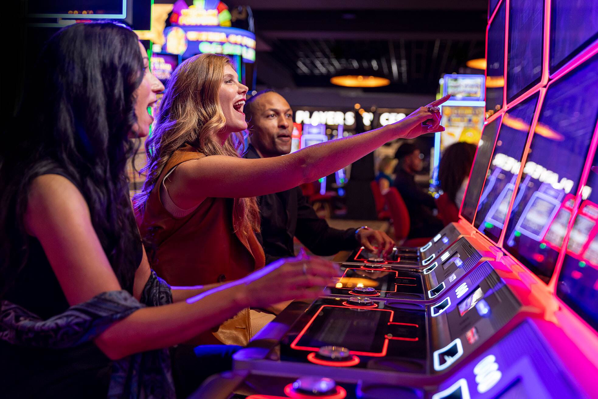 People playing slots on the casino floor